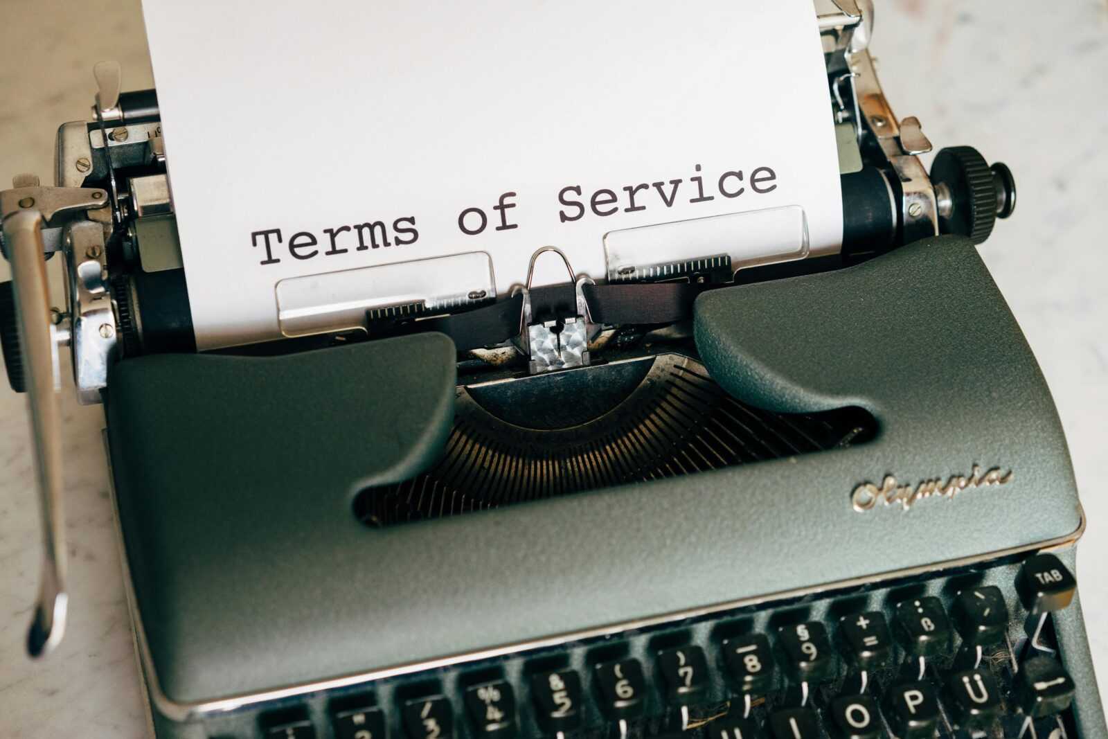 Close-up of a vintage typewriter printing 'Terms of Service' on paper, ideal for legal and business themes.